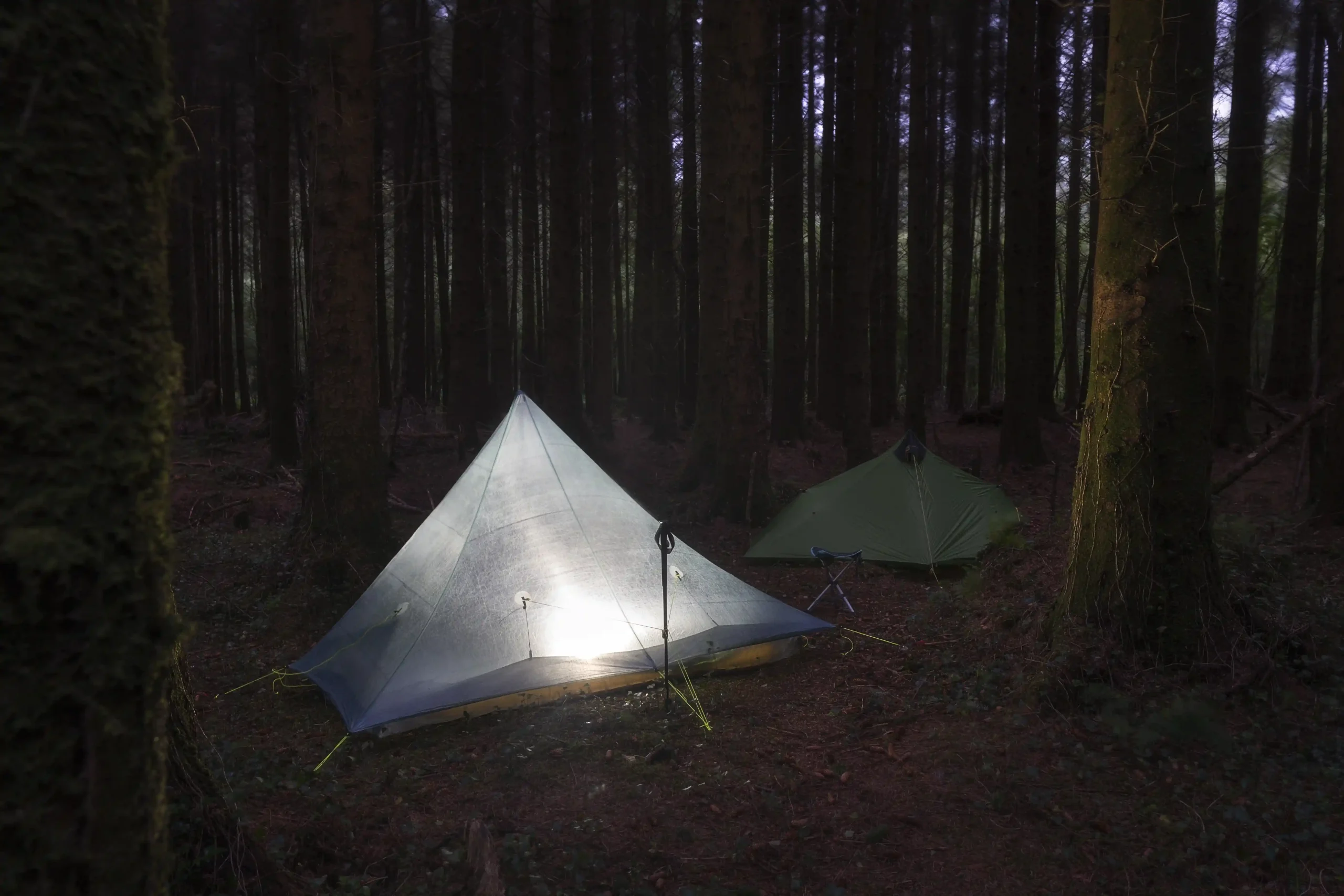 1-couple-camping-tents-mounted-middle-woods
