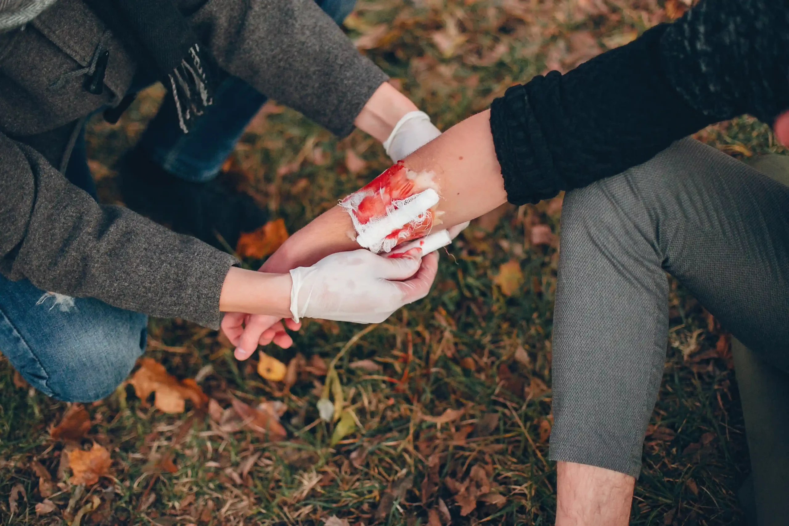 1-providing-first-aid-park-man-bandaged-injured-arm-guy-helps-friend